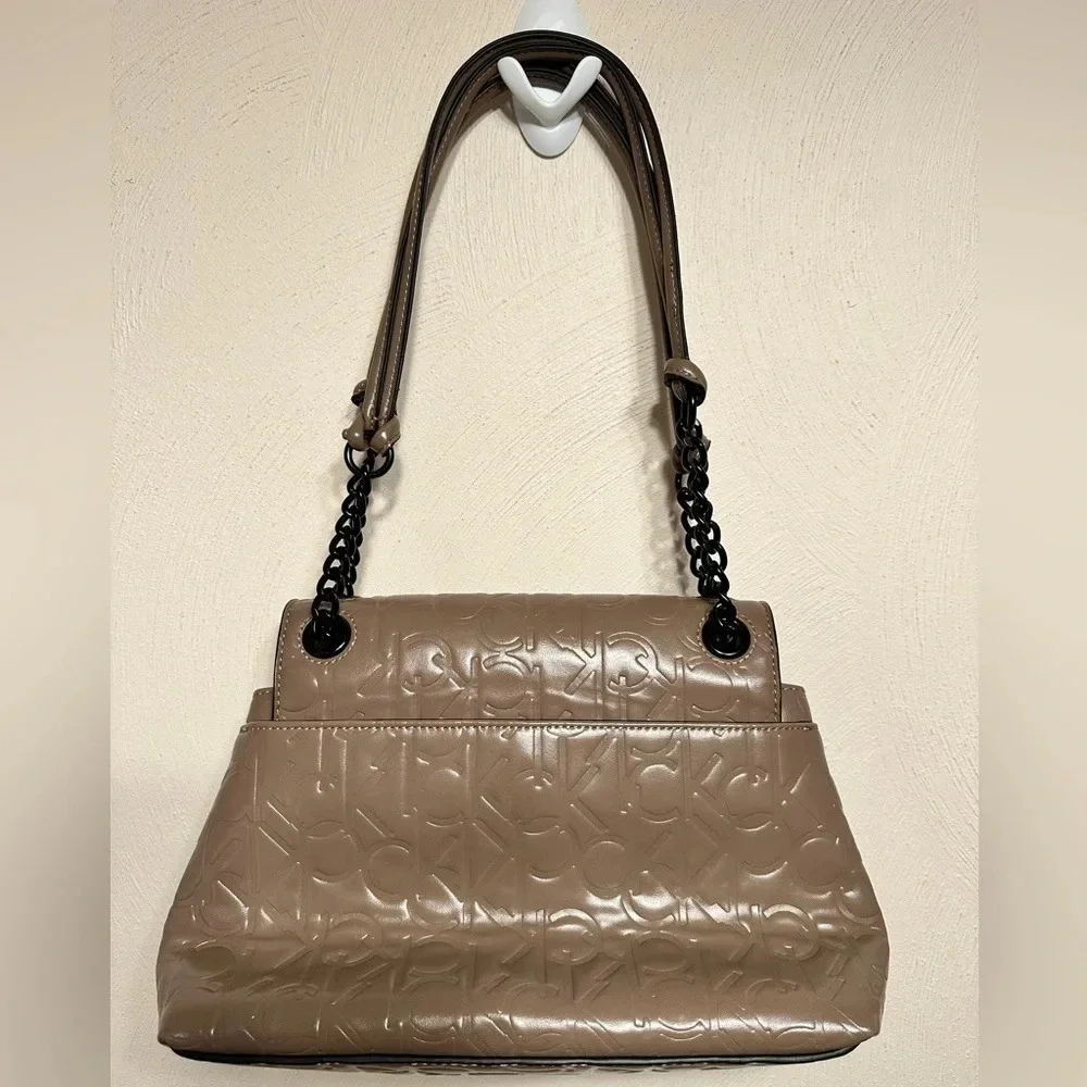 Calvin Klein logo purse. Leather and chain strap. Taupe color, 3 compartments